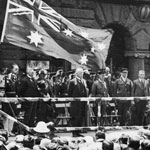 Armistice Day in Sydney, 11 November 1922. The main ceremony took place in Martin Place where the Governor of New South Wales, Sir Walter Davidson, and the Premier of New South Wales, Sir George Fuller, addressed the crowd from a platform erected in front of the General Post Office. Next to the platform were guards of honour from the Royal Australian Navy, the Royal Australian Garrison Artillery and the 1st and 2nd Senior Cadets. The 17th Battalion Band was also in attendance.  PN-002646