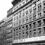 Advertisements for the Seventh War Loan, ‘Save and Serve Buy A War Loan’, on the Commonwealth Bank of Australia’s head office, Moore Street (now Martin Place), Sydney, 17 September 1918. The model destroyer that was the centrepiece of this campaign can be seen to the left of the photograph. PN-001778